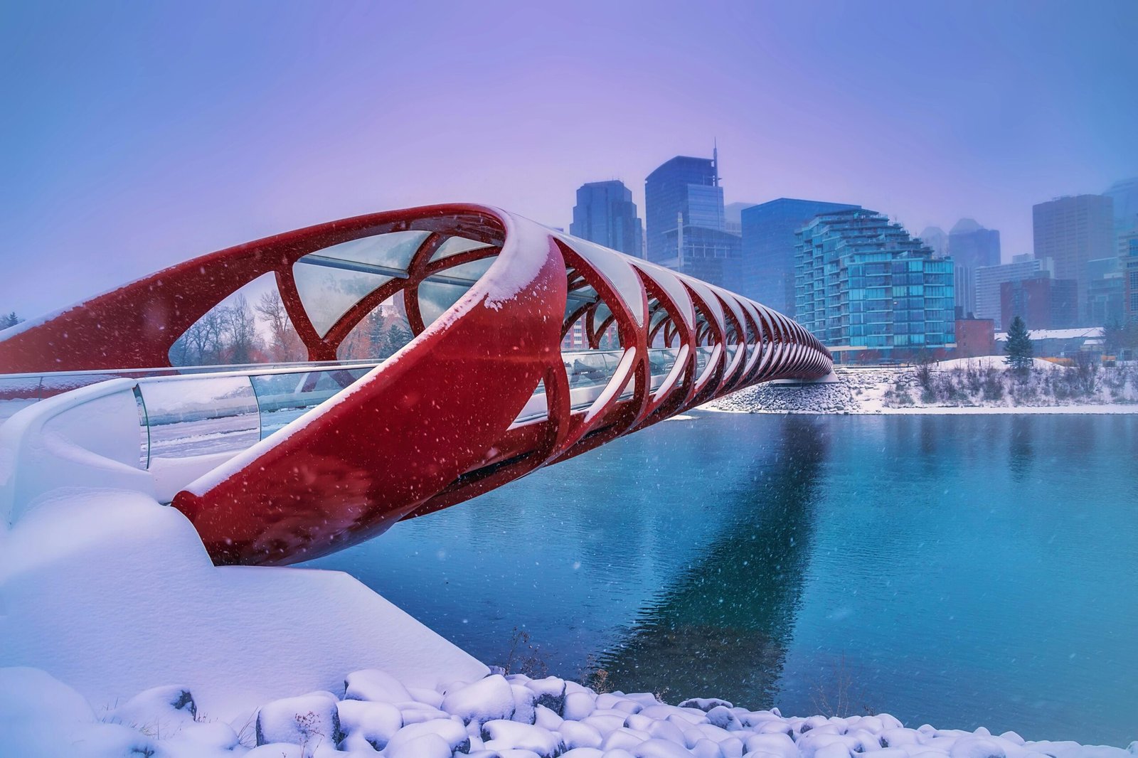 A captivating view of the Peace Bridge in Calgary covered in snow during winter.