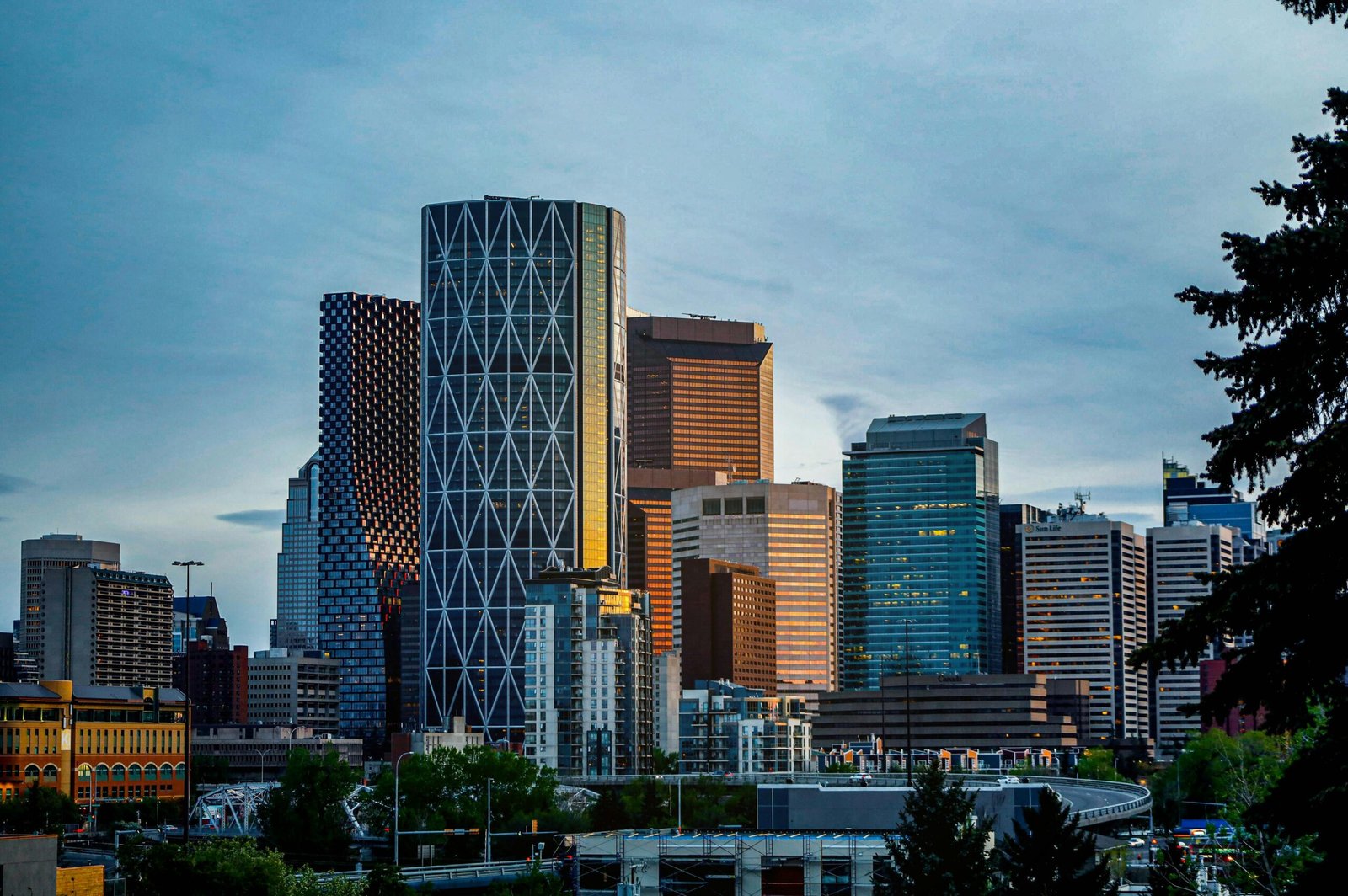 Explore the vibrant skyline of Calgary, AB, Canada with modern skyscrapers during dusk.