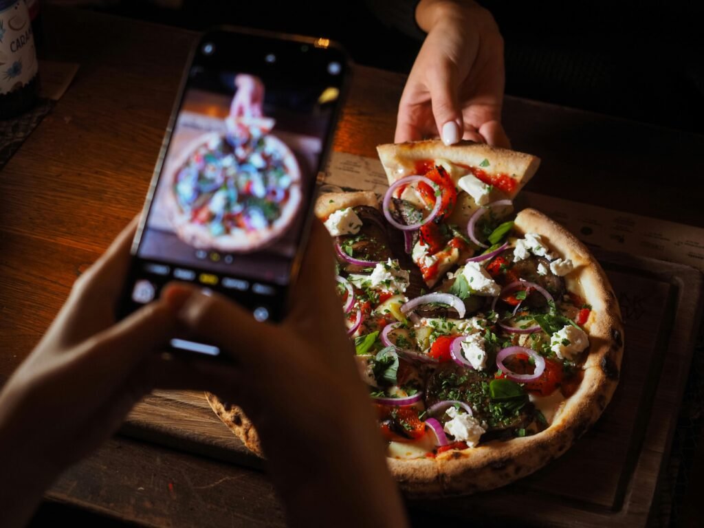 Close-up of gourmet pizza with toppings captured with a smartphone for food photography.