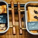 A tempting display of gluten-free brownies and blondies in trays, perfect for dessert lovers.