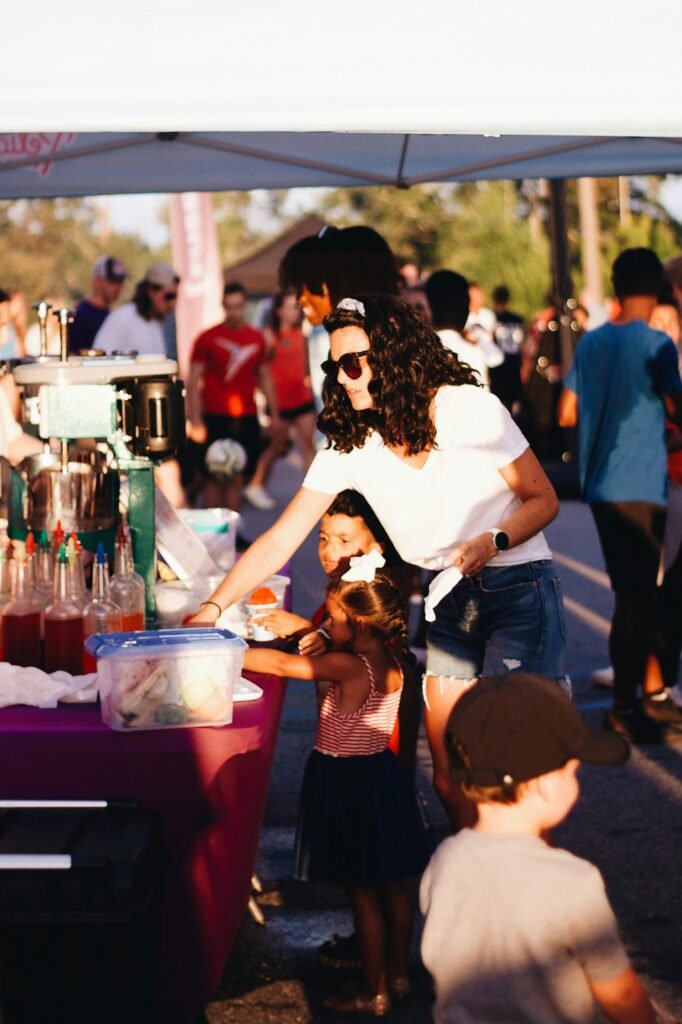 Families enjoy sweet treats at a vibrant summer festival in Clemson.