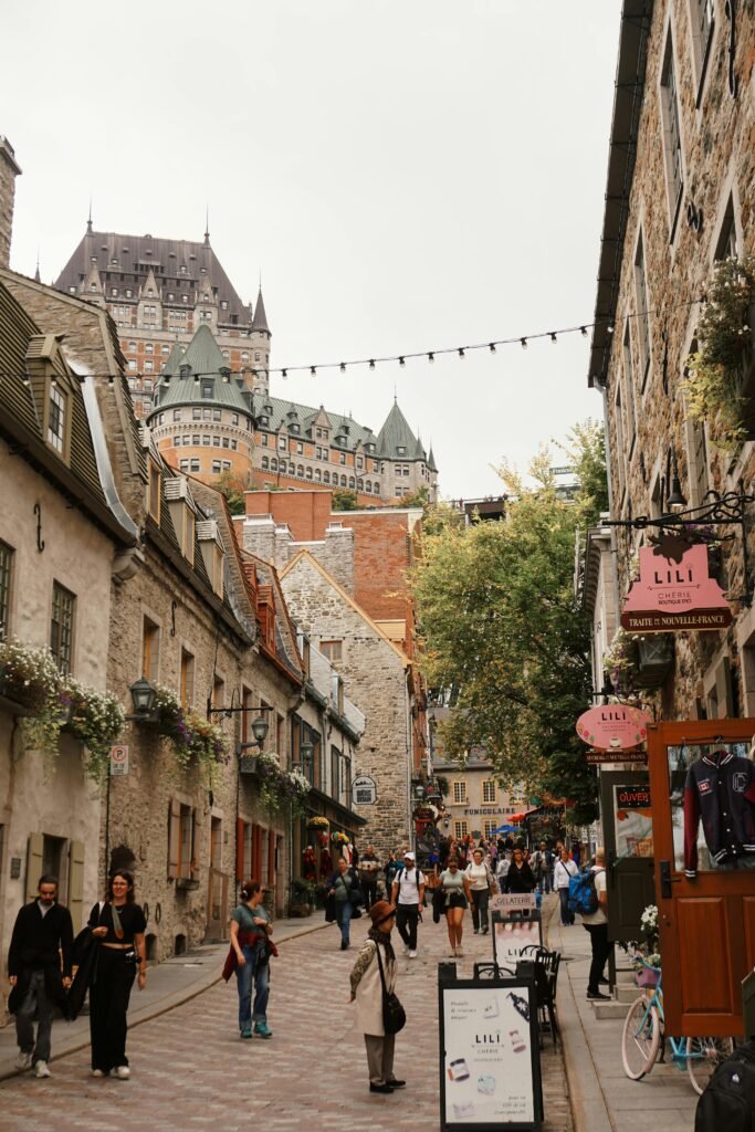 Bustling street scene in historic Old Québec with Château Frontenac in the background.