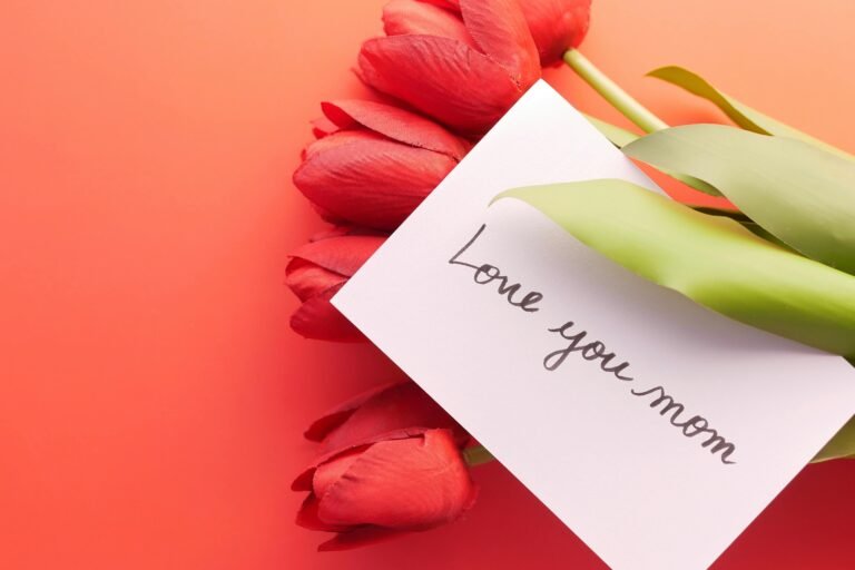Red tulips and a 'Love you mom' card perfect for Mother's Day greetings.