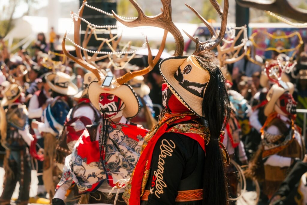 Vibrant costumes and antler headdresses at a cultural festival in Pachuca, Mexico.